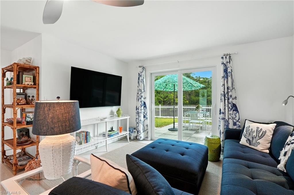 578 14th Street North Naples, FL 34102 - Photo 7 of 28 a living room with furniture and a flat screen tv