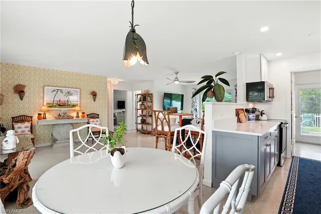 a dining room with furniture garden view and wooden floor