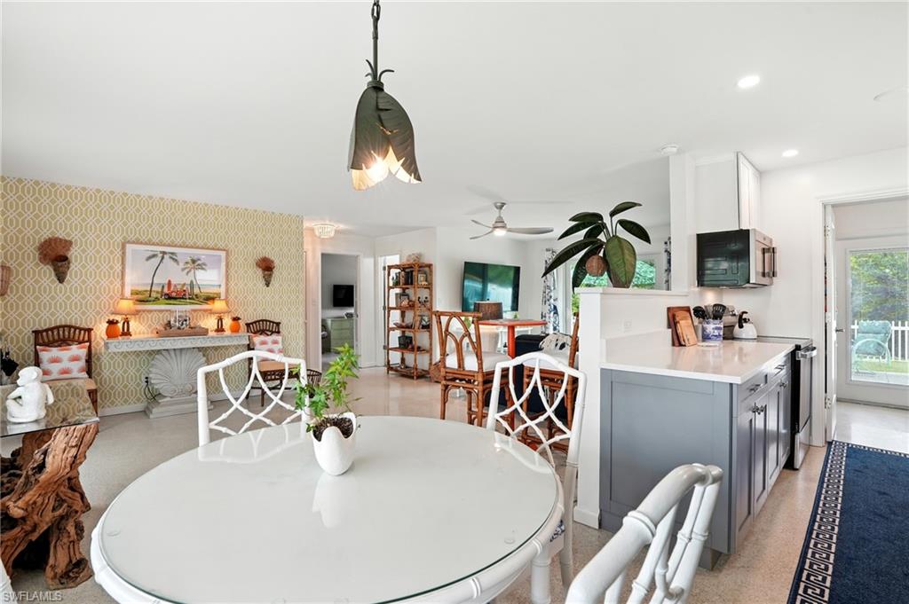 578 14th Street North Naples, FL 34102 - Photo 9 of 28 a dining room with furniture garden view and wooden floor