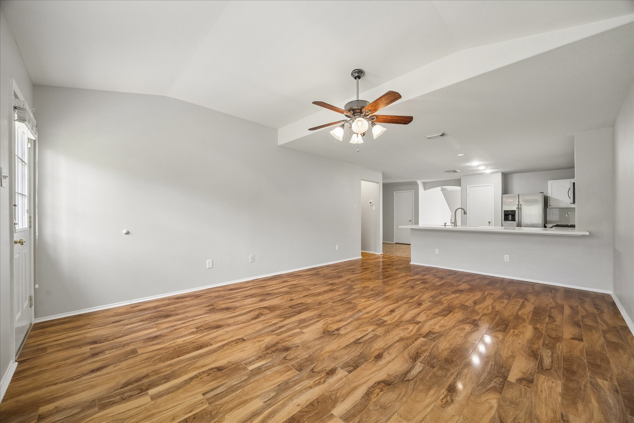 223 Sunset Colony Drive Rosharon, TX 77583 - Photo 14 of 50 With room to spread out, relax and enjoy the comforts of home, this spacious family room feels open and inviting with fresh paint, wood-look laminate flooring and a cooling ceiling fan set beneath the vaulted ceiling.