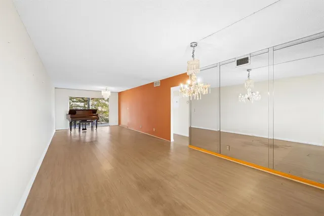 a view of a livingroom with furniture wooden floor and window