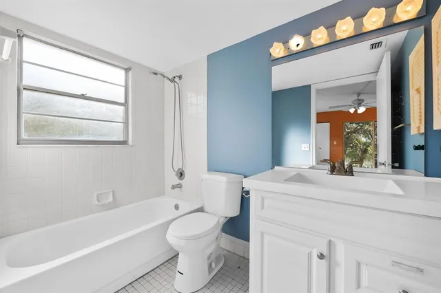 a bathroom with a sink a toilet and bathtub
