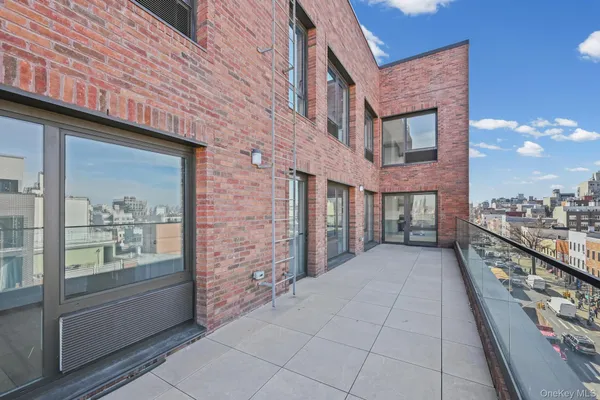 a view of a brick house with a large windows