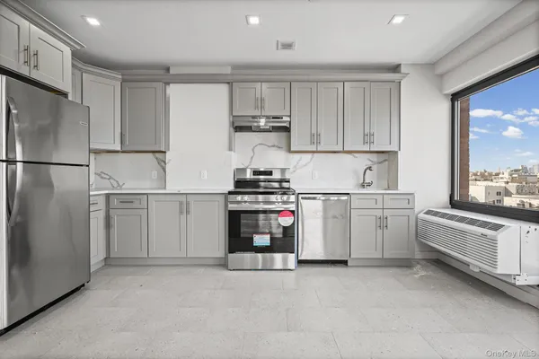 a kitchen with white cabinets and white appliances