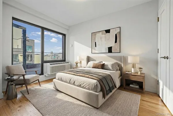 a bedroom with a bed and glass window