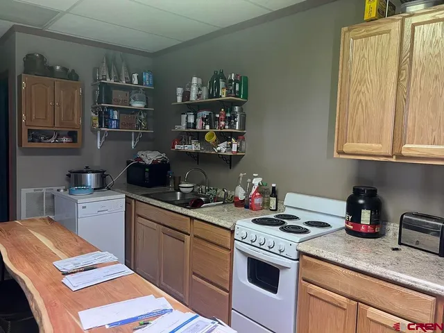 a kitchen with a stove and cabinets