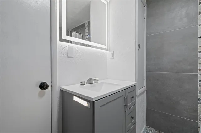 a bathroom with a sink toilet and window