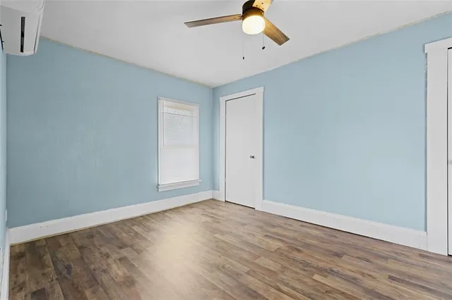 a view of an empty room with wooden floor