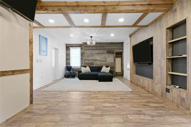 a living room with furniture and a flat screen tv