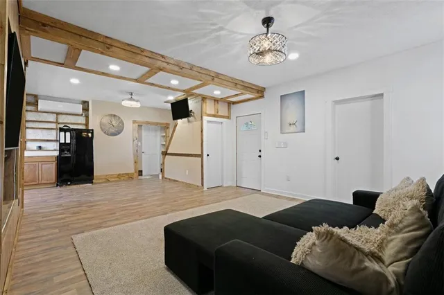 a living room with furniture and a chandelier