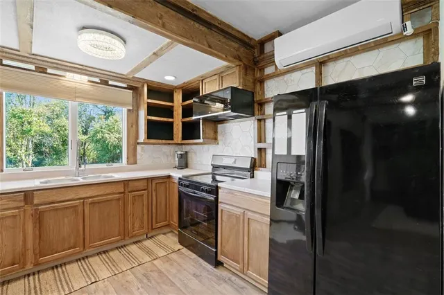 a kitchen with a sink window and cabinets