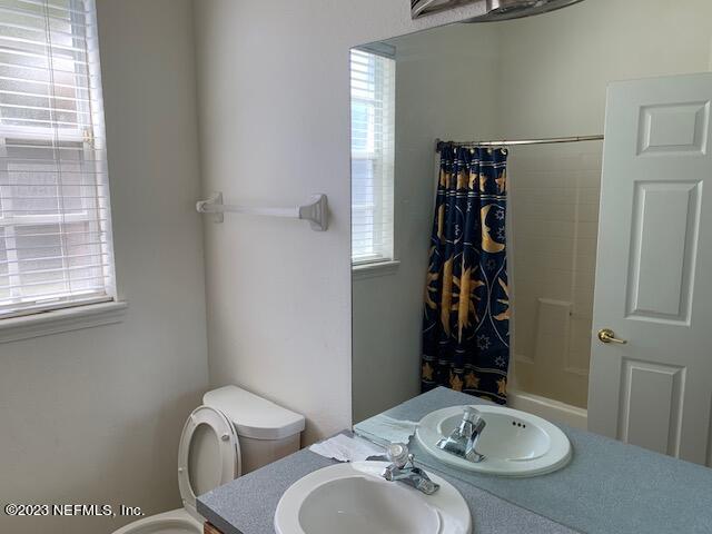 10550 Baymeadows Road, Unit 618 Jacksonville, FL 32256 - Photo 12 of 15 a bathroom with a sink a toilet and shower