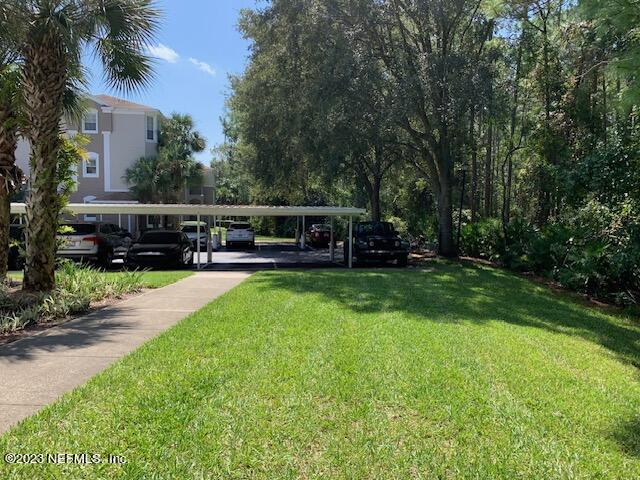 10550 Baymeadows Road, Unit 618 Jacksonville, FL 32256 - Photo 4 of 15 a view of a house with a yard