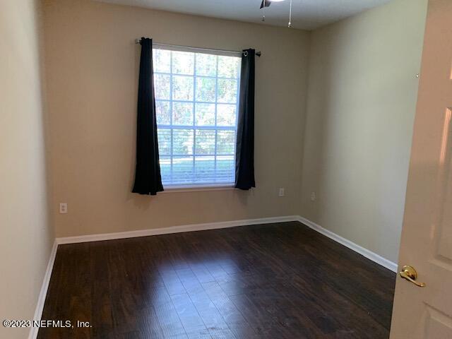 10550 Baymeadows Road, Unit 618 Jacksonville, FL 32256 - Photo 10 of 15 an empty room with wooden floor and windows