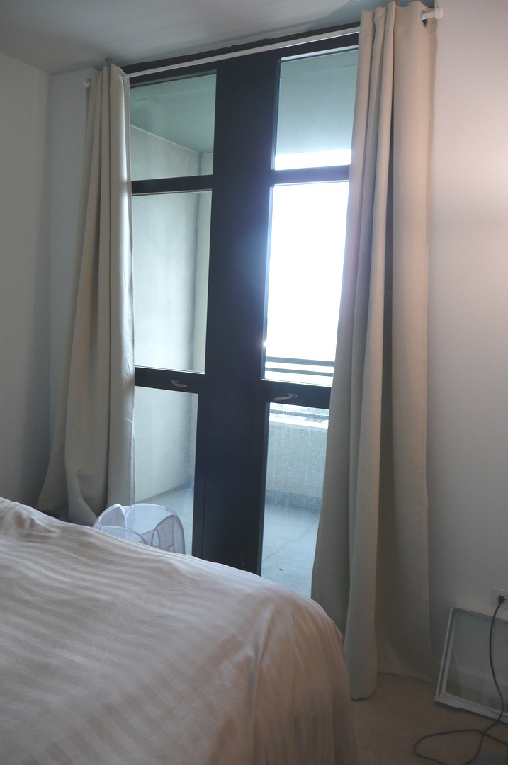 1255 South State Street, Unit 1414 Chicago, IL 60605 - Photo 15 of 24 a bedroom with a bed and a mirror