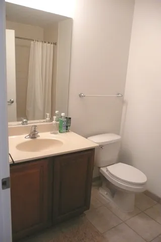 a bathroom with a sink toilet and a mirror