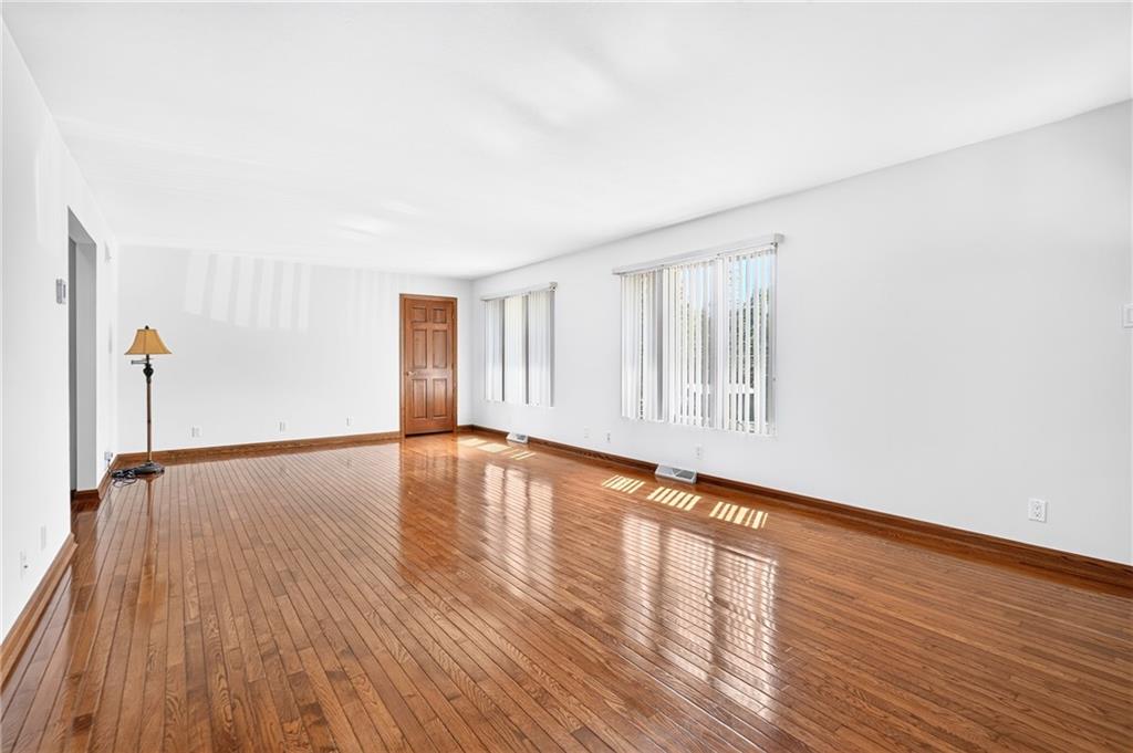 312 Gringo Independence Road, Unit R Aliquippa, PA 15001 - Photo 10 of 49 The spacious living room welcomes you with gleaming hardwood floors, abundant natural light, and neutral paint create a bright, warm, and inviting space that is ready to compliment any decor.