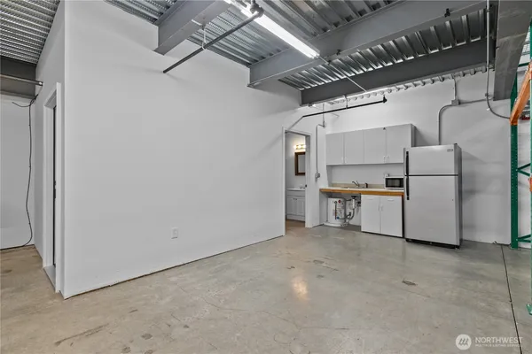 a kitchen with refrigerator and cabinets