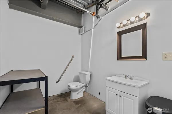 a bathroom with a toilet sink and mirror