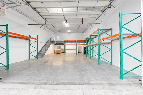 a view of an empty room with furniture and a window