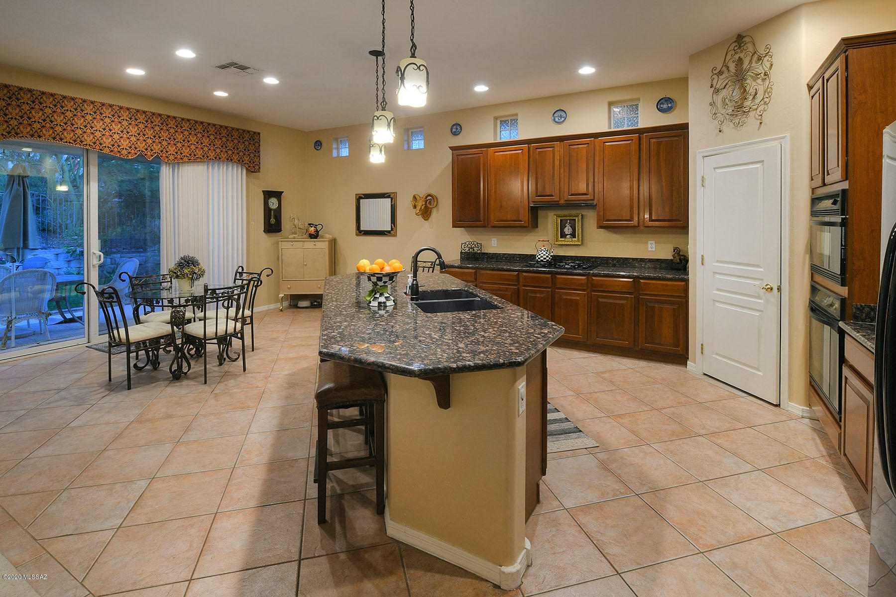 12740 North Morgan Ranch Road Oro Valley, AZ 85755 - Photo 11 of 32 a kitchen with stainless steel appliances granite countertop a stove a sink a refrigerator and a dining table