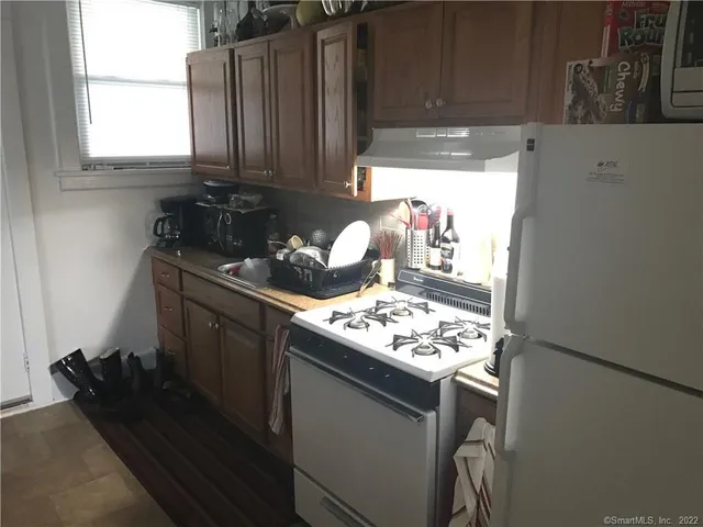 a kitchen with a stove and a refrigerator