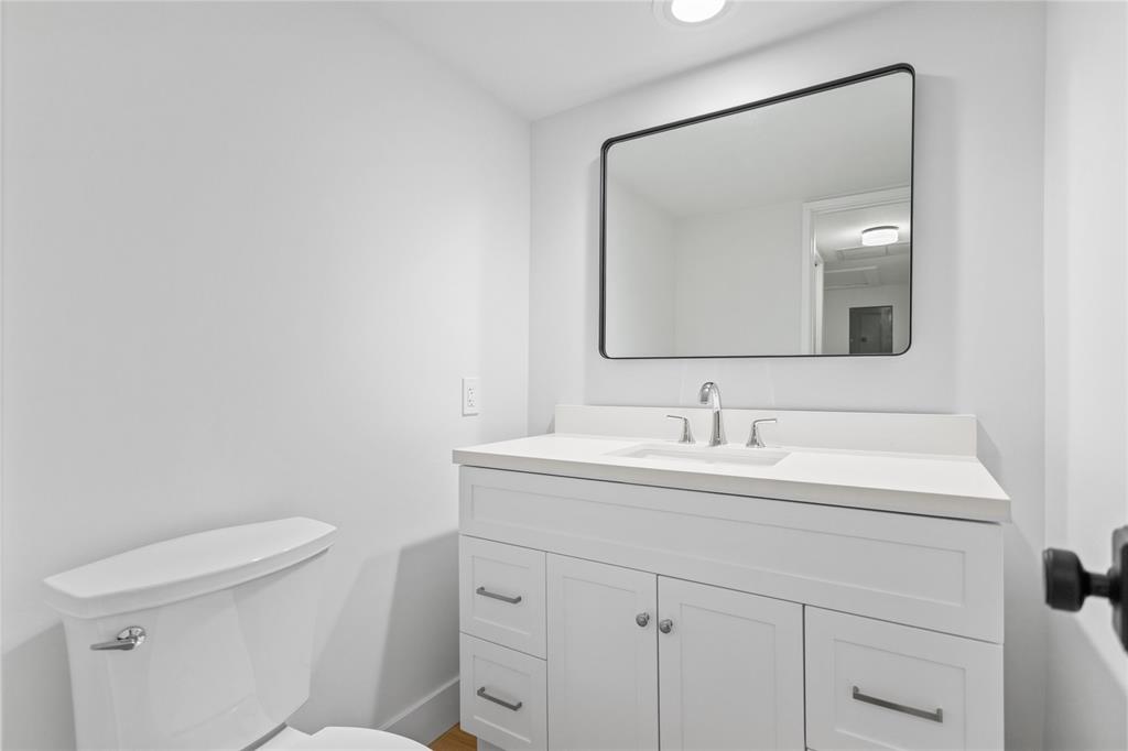 3000 South Course Drive, Unit 607 Pompano Beach, FL 33069 - Photo 17 of 33 a bathroom with a toilet a sink and mirror
