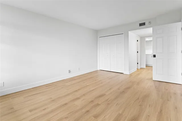 a view of an empty room and wooden floor