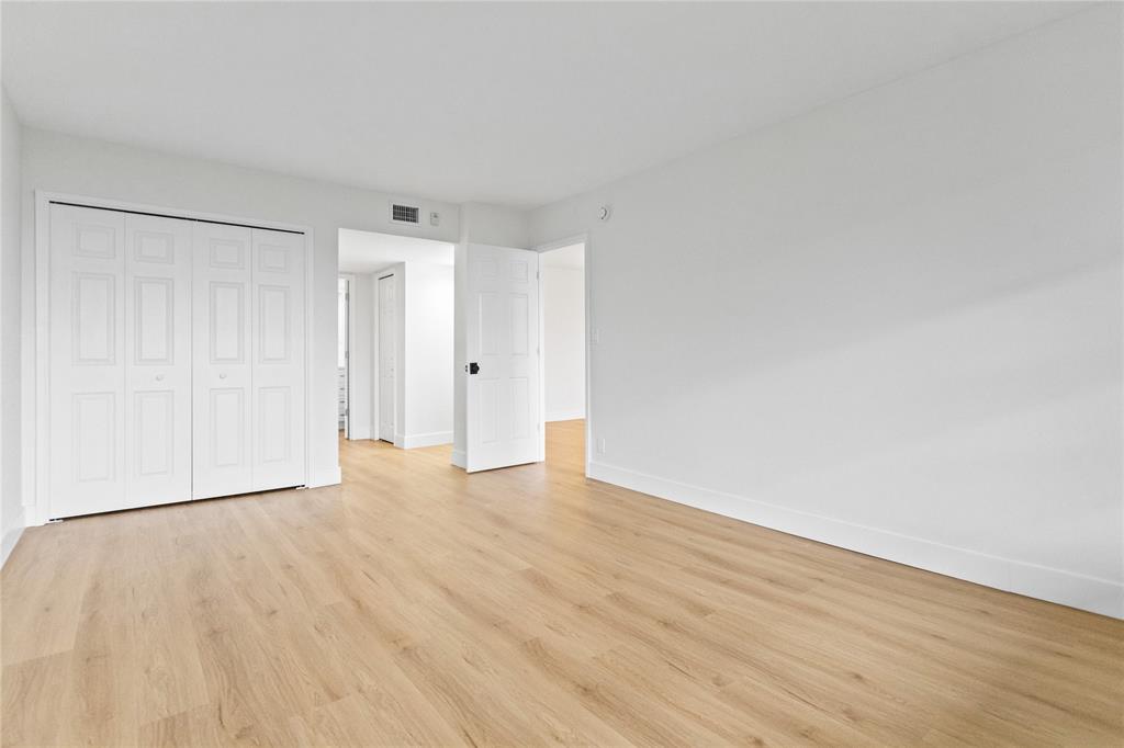 3000 South Course Drive, Unit 607 Pompano Beach, FL 33069 - Photo 19 of 33 a view of an empty room and wooden floor