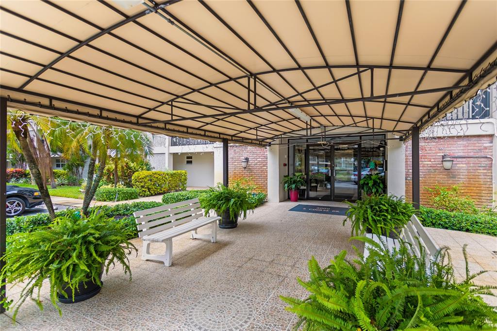 3000 South Course Drive, Unit 607 Pompano Beach, FL 33069 - Photo 2 of 33 a view of a porch with plants and a potted plant