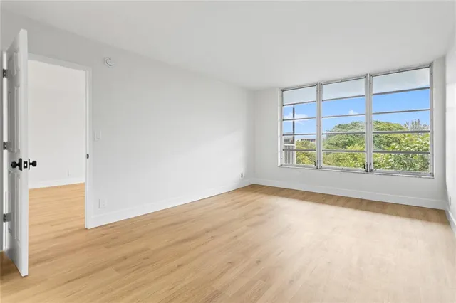 a view of a room with wooden floor