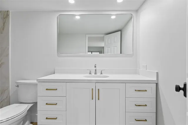 a spacious bathroom with a double vanity sink and a mirror