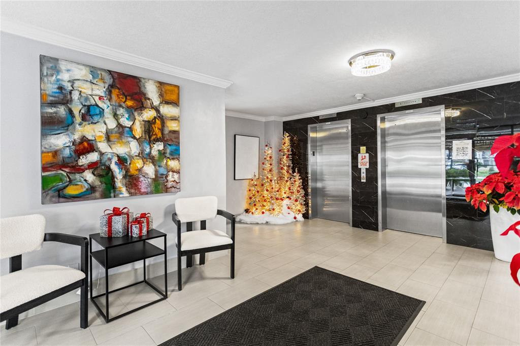 3000 South Course Drive, Unit 607 Pompano Beach, FL 33069 - Photo 4 of 33 a living room with furniture and flowers