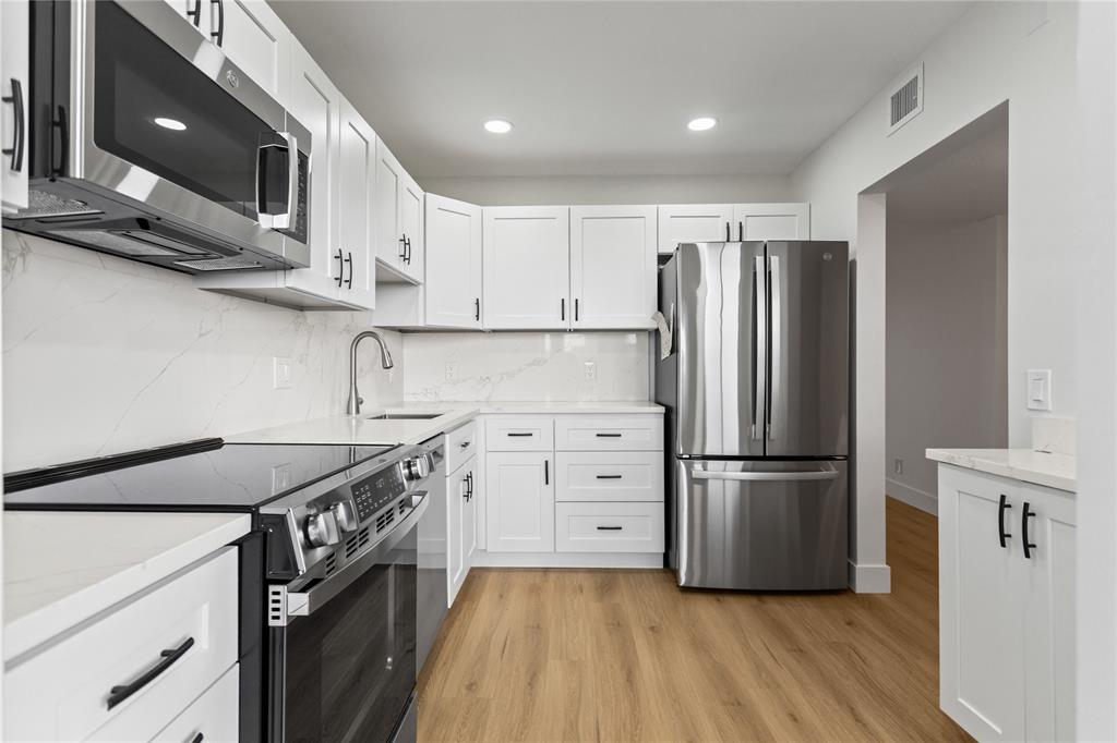 3000 South Course Drive, Unit 607 Pompano Beach, FL 33069 - Photo 8 of 33 a kitchen with stainless steel appliances granite countertop a refrigerator a stove and a microwave