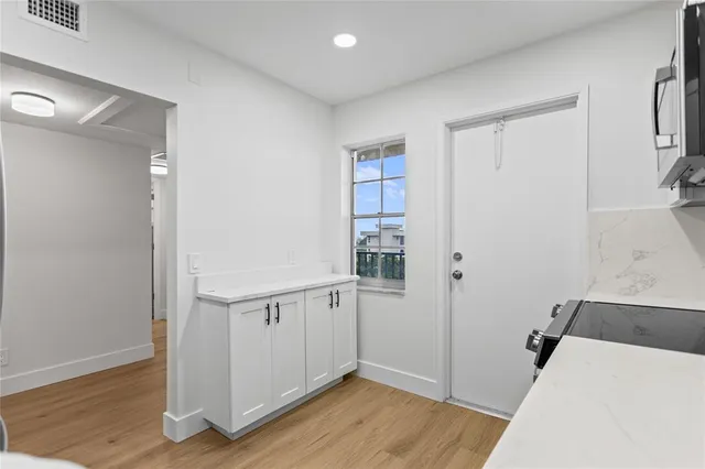 a kitchen with stainless steel appliances a stove microwave and refrigerator