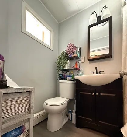 a bathroom with a sink toilet and mirror