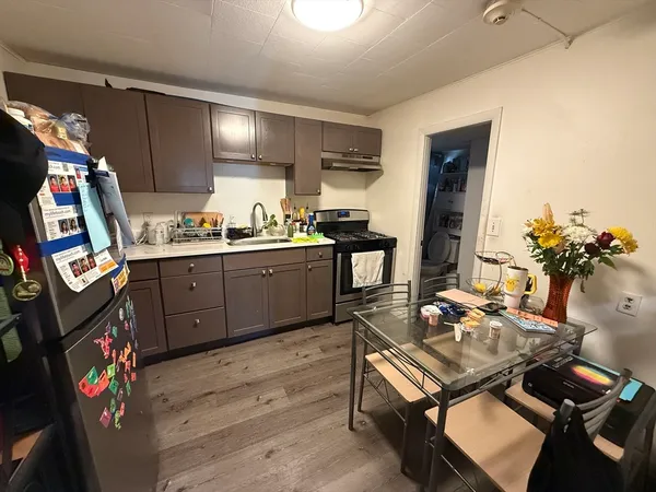 a kitchen with a sink appliances and cabinets