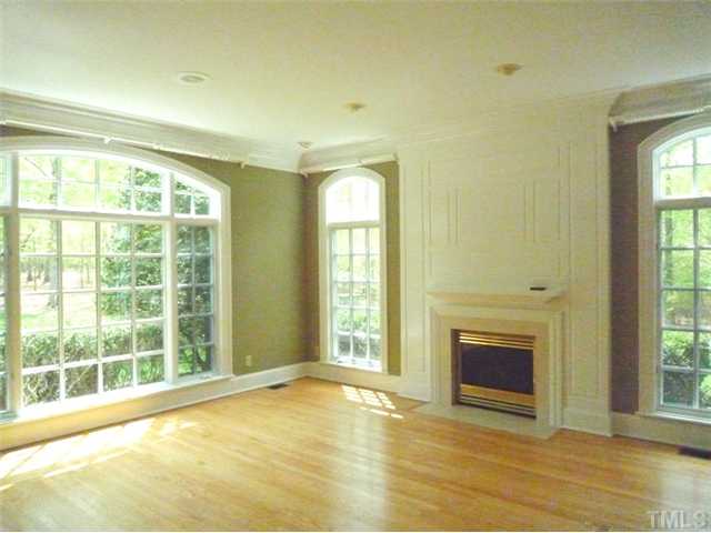 1817 Brassfield Road Raleigh, NC 27614 - Photo 11 of 25 a view of an empty room with a fireplace and a window