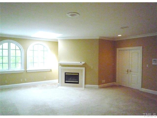 1817 Brassfield Road Raleigh, NC 27614 - Photo 12 of 25 an empty room with windows and fireplace