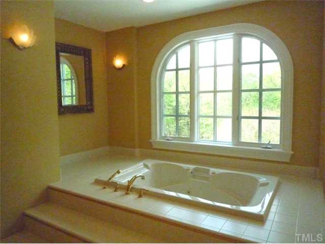 1817 Brassfield Road Raleigh, NC 27614 - Photo 14 of 25 a bath tub sitting next to a window