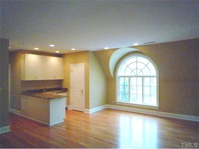1817 Brassfield Road Raleigh, NC 27614 - Photo 17 of 25 an empty room with wooden floor and a window