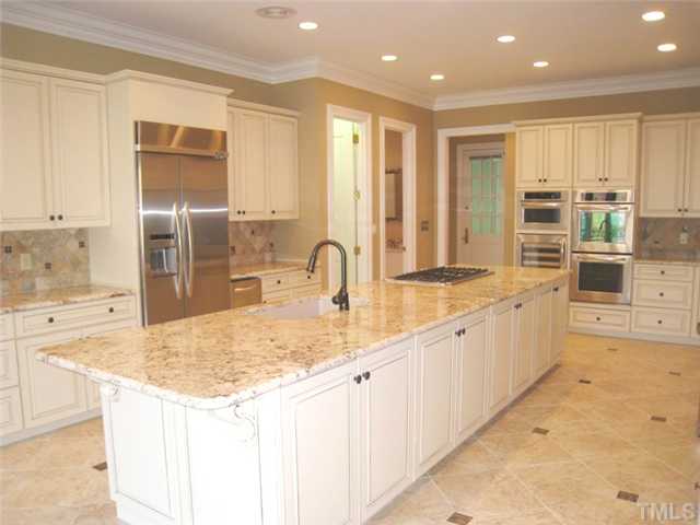 1817 Brassfield Road Raleigh, NC 27614 - Photo 4 of 25 a kitchen with stainless steel appliances granite countertop a sink and cabinets