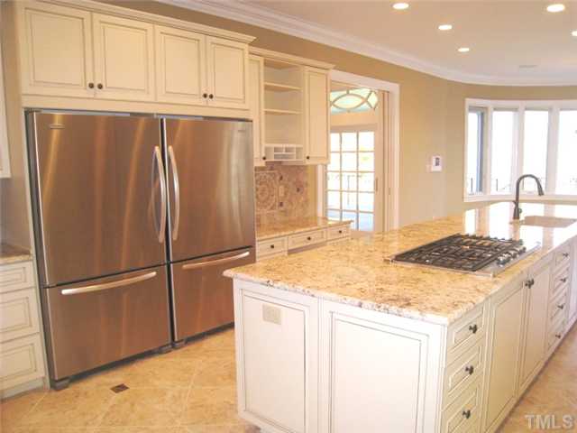 1817 Brassfield Road Raleigh, NC 27614 - Photo 5 of 25 a kitchen with granite countertop a refrigerator and a stove top oven