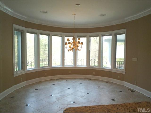 1817 Brassfield Road Raleigh, NC 27614 - Photo 7 of 25 an empty room with a empty space and windows
