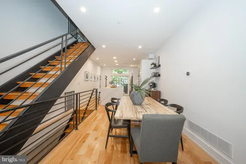 a dining room with furniture and wooden floor
