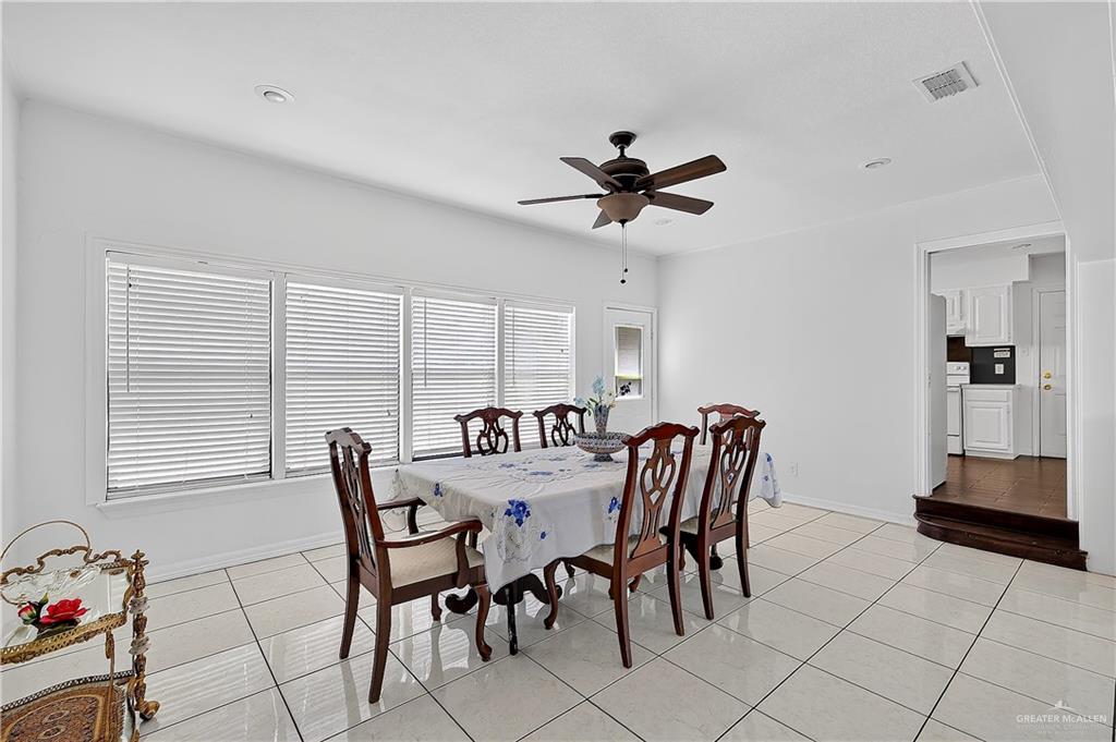 216 West Enfield Road Edinburg, TX 78539 - Photo 6 of 20 White tile flooring, multiple large windows with blinds, ceiling fan, and recessed lighting