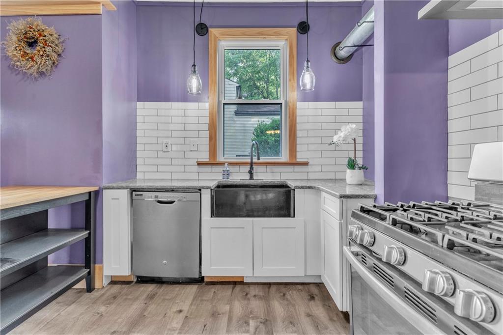 69 Transvaal Avenue Pittsburgh, PA 15212 - Photo 11 of 37 a kitchen with a stove a sink and a microwave
