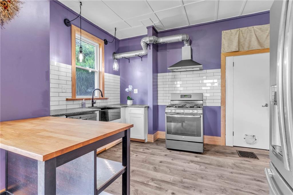 69 Transvaal Avenue Pittsburgh, PA 15212 - Photo 12 of 37 a kitchen with stainless steel appliances granite countertop a stove a refrigerator and a stove