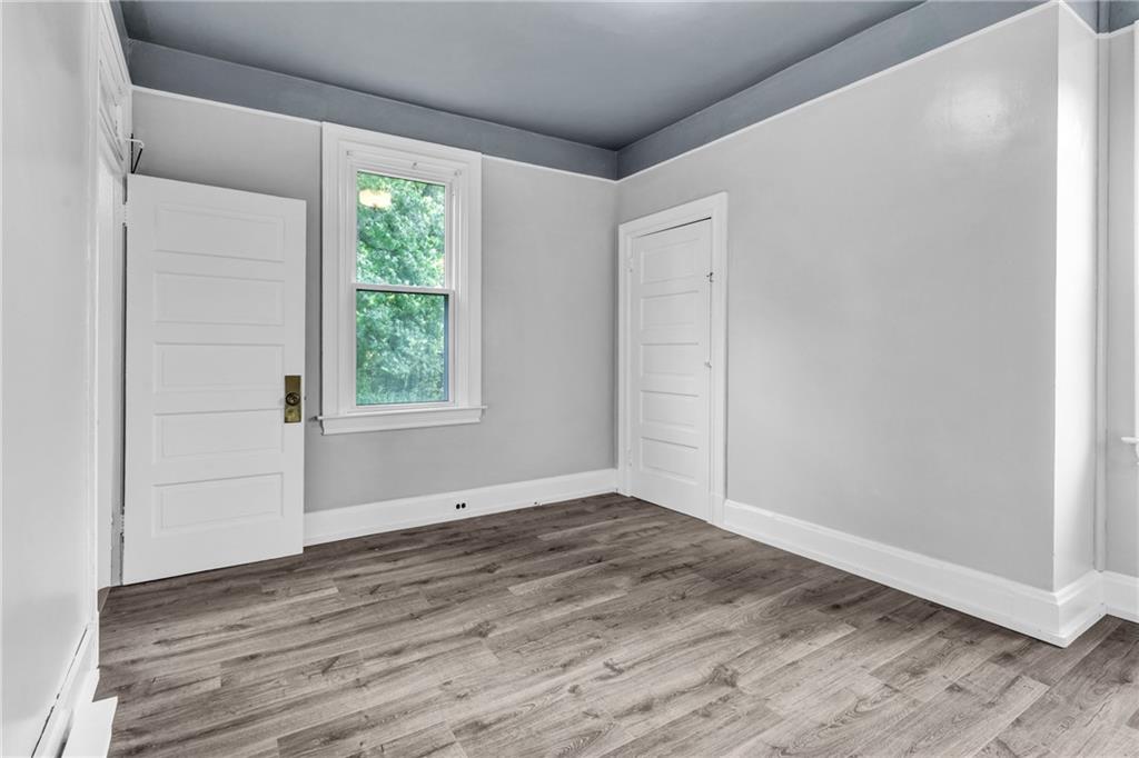 69 Transvaal Avenue Pittsburgh, PA 15212 - Photo 20 of 37 a view of an empty room with wooden floor and a window
