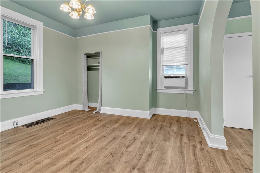 69 Transvaal Avenue Pittsburgh, PA 15212 - Photo 9 of 37 a view of an empty room with wooden floor and a window